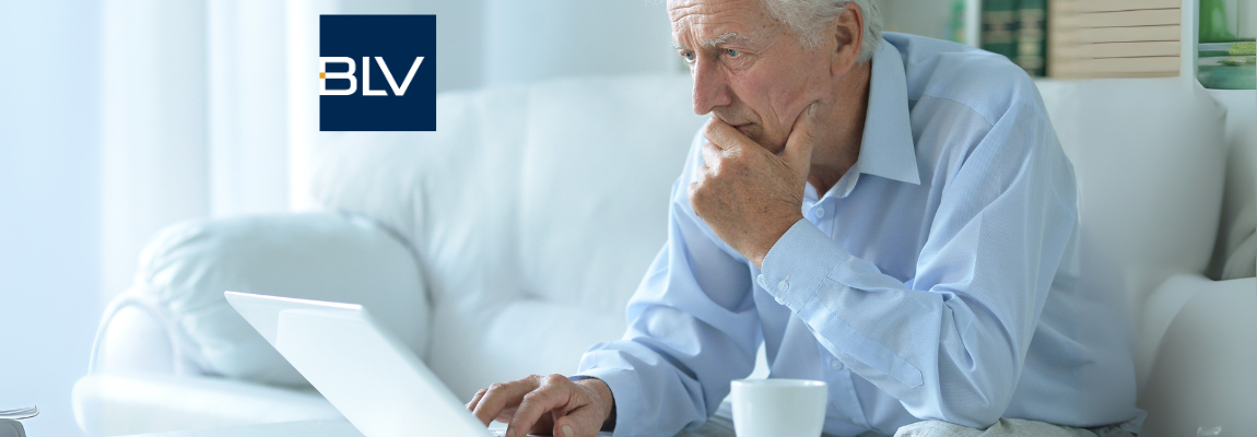 senior man at home with laptop